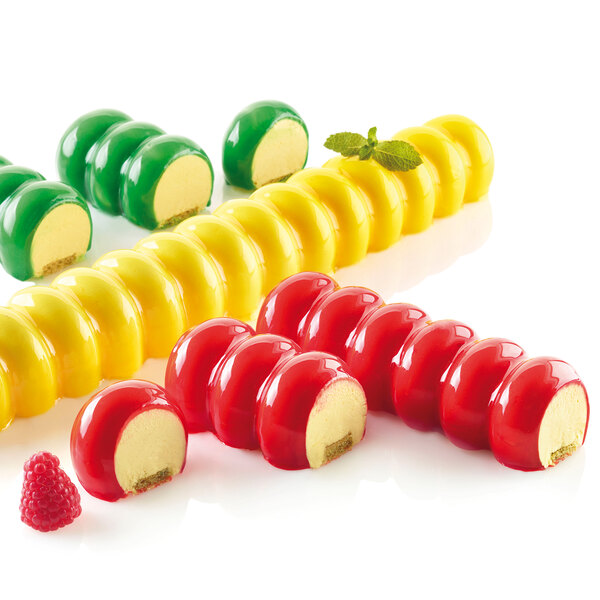 A group of colorful desserts in a Silikomart silicone baking mold.