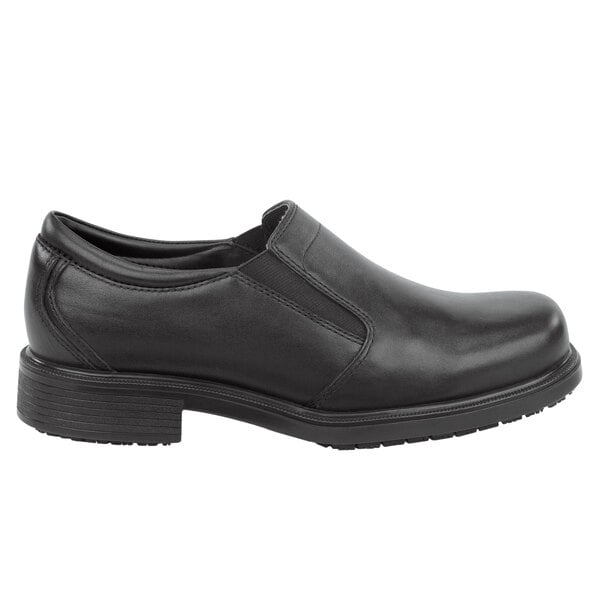 A Rockport Works men's black slip-on dress shoe with a thin rubber sole.