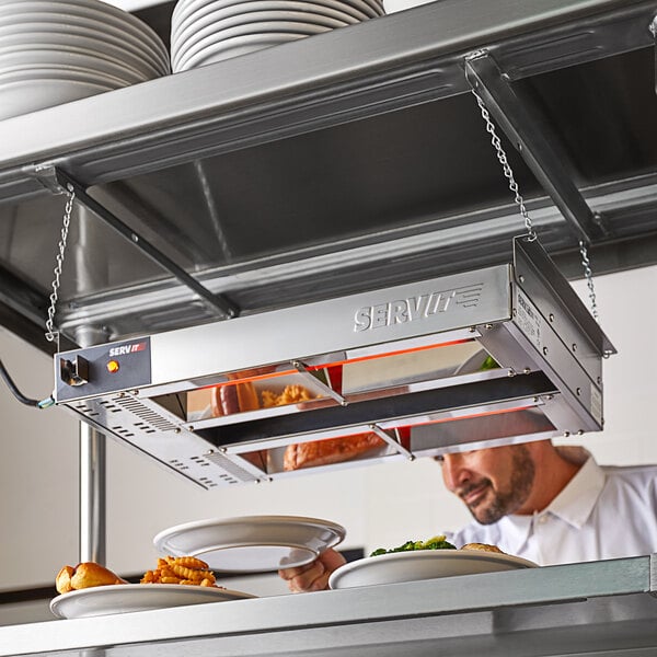 silver hanging heat lamp over plates of food
