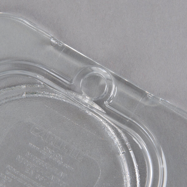 A Carlisle clear plastic lid for a food container.
