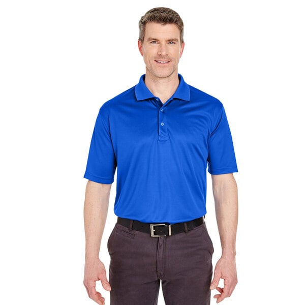 A man wearing a royal blue Henry Segal performance polo shirt.