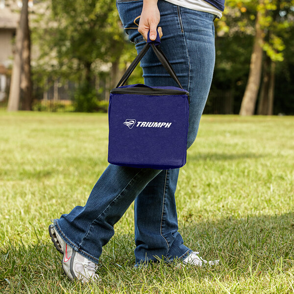 A person carrying a blue Triumph Bocce Set bag.