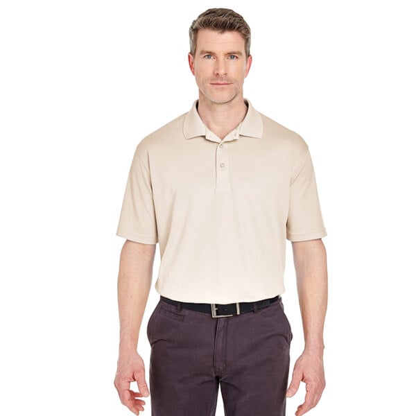 A man wearing a beige Henry Segal polo shirt.