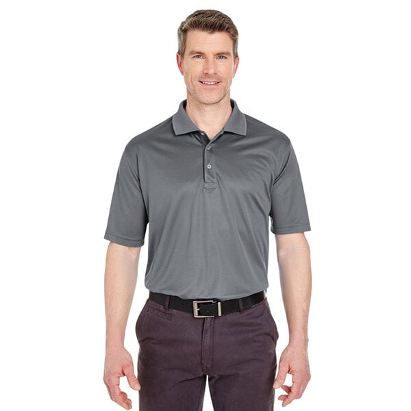 A man wearing a Henry Segal charcoal grey performance polo shirt.