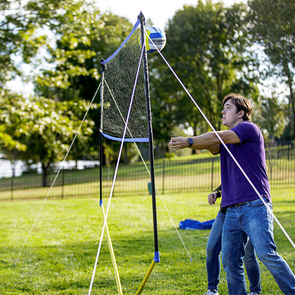 A man playing volleyball with a Triumph multi-sport net.