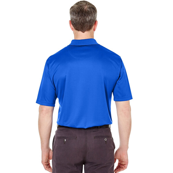 A man wearing a royal blue Henry Segal polo shirt.