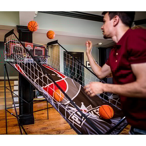 A man playing Triumph Playmaker Double Shootout basketball.