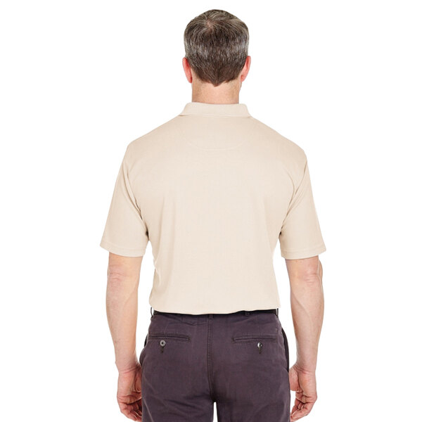 A man wearing a tan Henry Segal polo shirt.