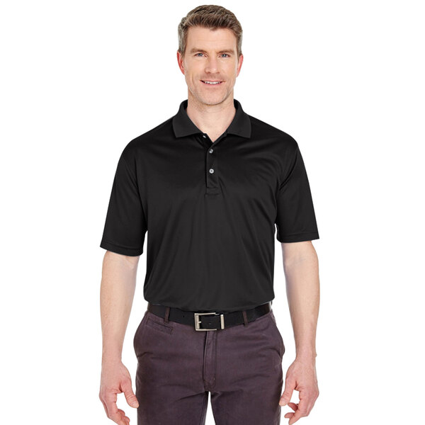 A man wearing a black Henry Segal performance polo shirt.