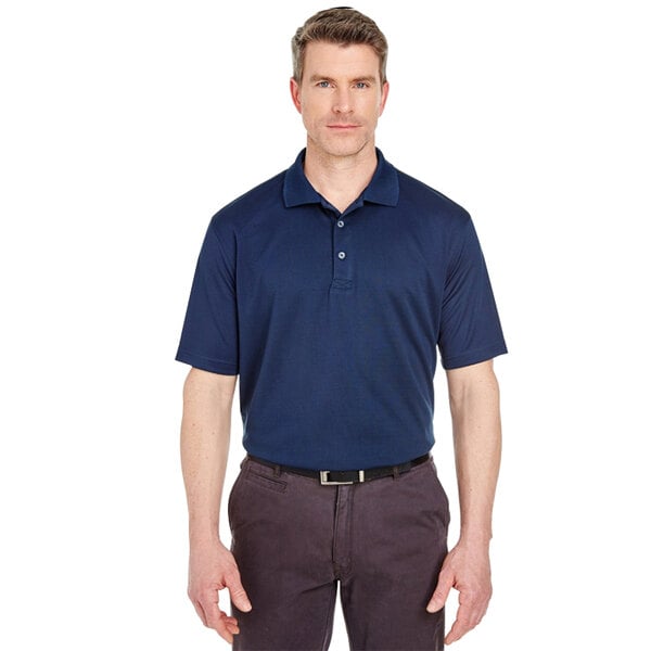 A man wearing a navy Henry Segal performance polo shirt.