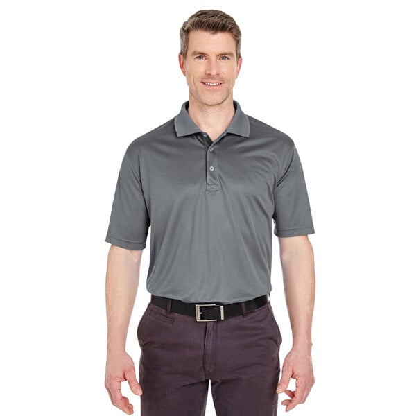 A man wearing a charcoal gray Henry Segal performance polo shirt.