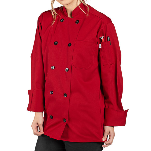 A woman wearing a red Uncommon Chef long sleeve chef coat.