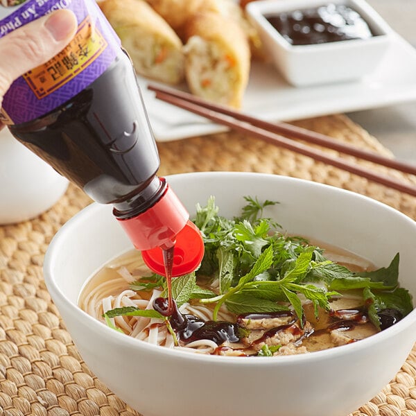 Drizzling hoisin sauce on soup