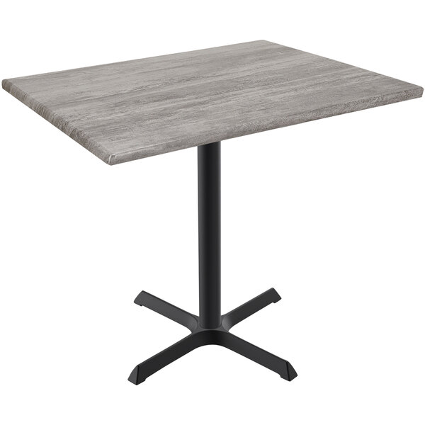 A Holland Bar Stool EnduroTop table with a greystone top and black cross base.