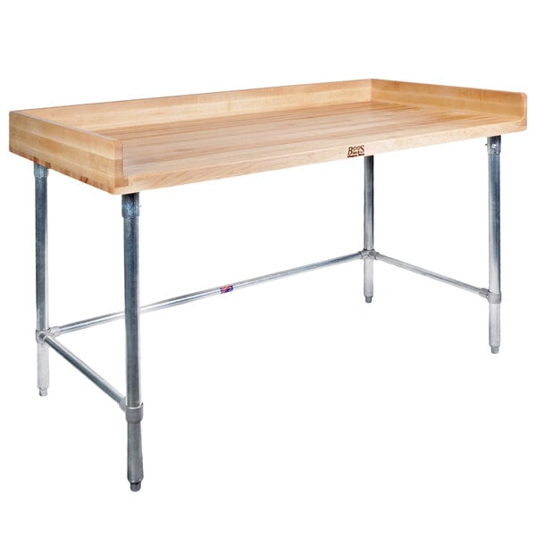 A John Boos wood top table with metal legs.