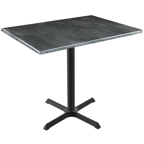 A Holland Bar Stool black steel wood laminate table top on a black metal table with a cross base.