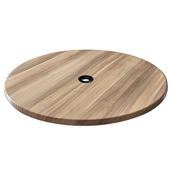 a round wooden table with a black hole