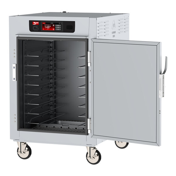 A large metal Metro heated holding cabinet with solid doors and an open door.