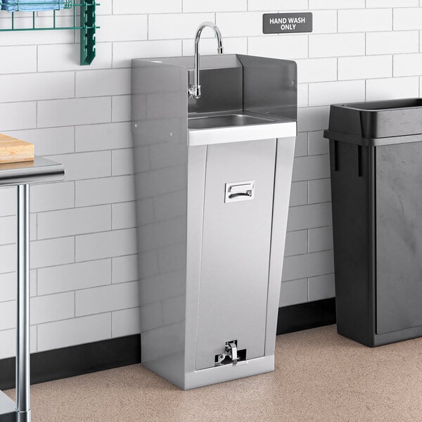 A white rectangular Regency hand sink with side splashes next to a stainless steel trash can.