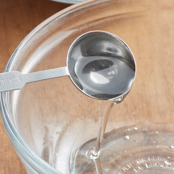 a small measuring spoon full of simple syrup