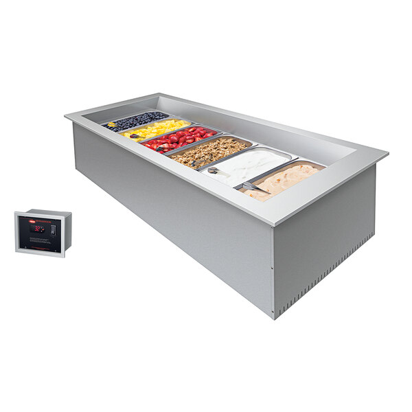 A Hatco drop-in cold food well with rectangular pans of food on a counter.
