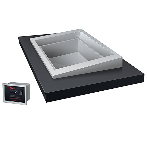 A white box with a black keypad on a black surface.