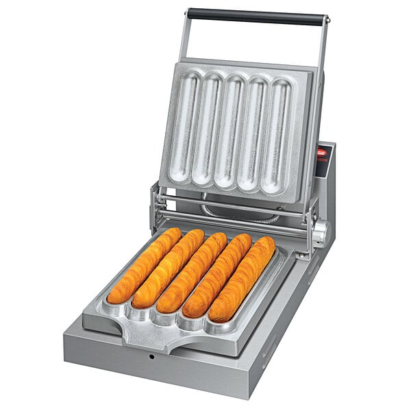 A Hatco Chelky plate for long orange food items in a machine.