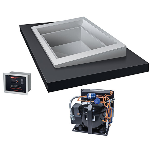 A black box with a white square box and a black box with orange wires.