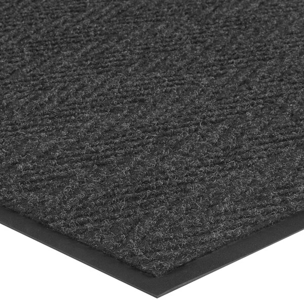A close-up of a black Lavex Chevron Rib carpet mat.