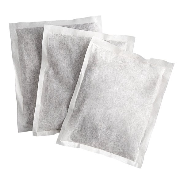 Three large rectangular filter bags filled with a dark substance, likely tea, are arranged overlapping on a white background.