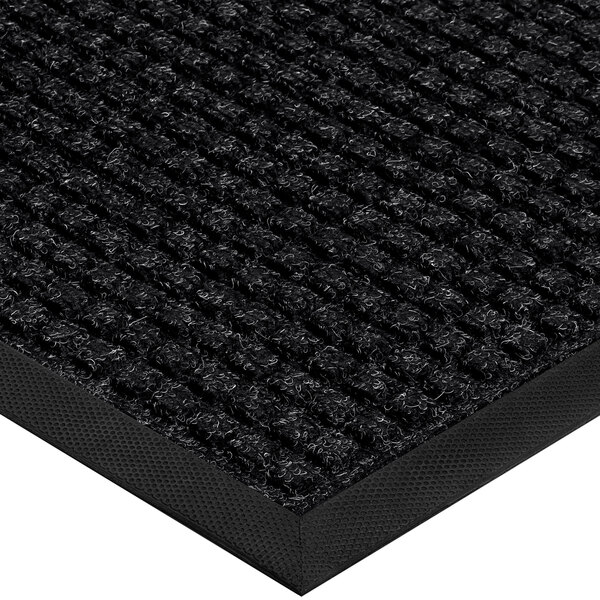A close-up of a black Lavex waffle entrance mat with a black border.