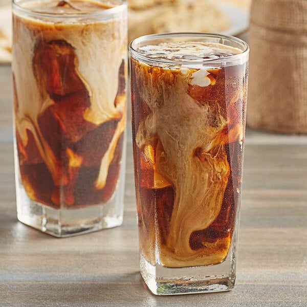 Two glasses of Caribou Coffee French Roast iced coffee with ice.
