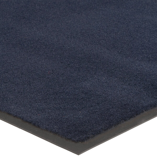 A Lavex navy blue olefin entrance mat with a black border.