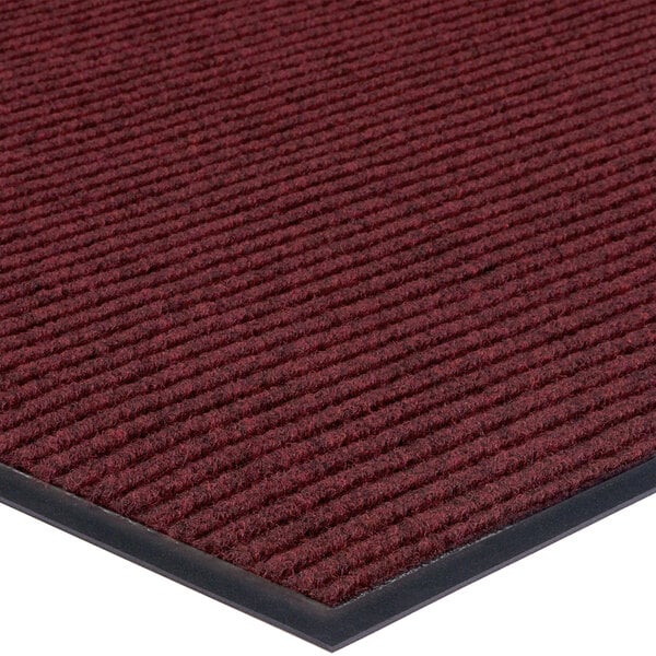 A red Lavex carpet entrance mat with black borders.