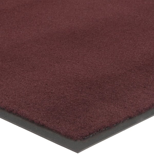 A close-up of a burgundy Lavex Olefin entrance mat with a black border.