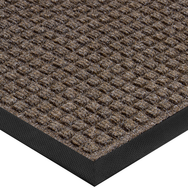 A white background with a close-up of a brown Lavex Waffle entrance mat with a black border.