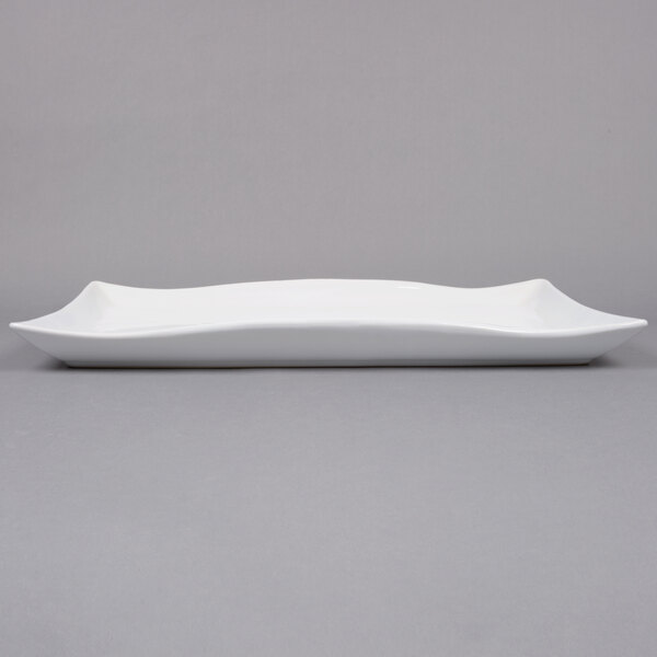 An American Metalcraft wavy rectangular stoneware platter on a white surface.