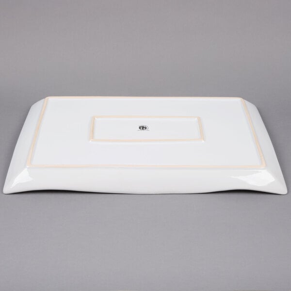 A white rectangular platter with a gold border.