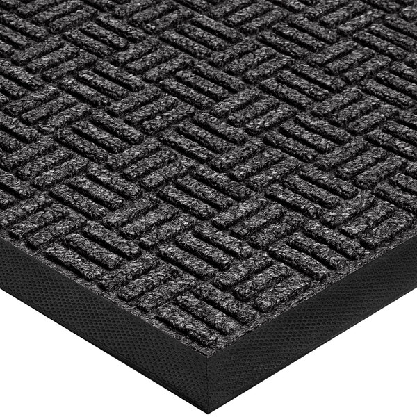 A close-up of a black rubber Lavex parquet entrance mat with a pattern on it.