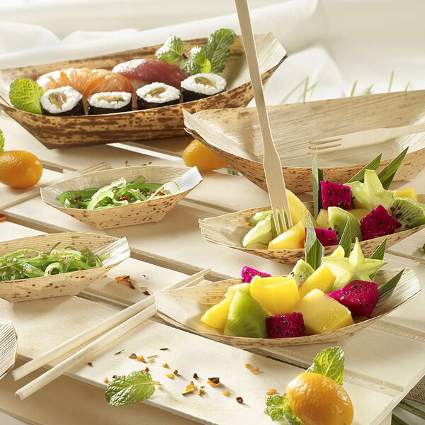 A table with Solia round thermoformed bowls filled with a variety of food.