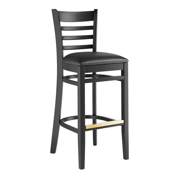 A black Lancaster Table & Seating bar stool with a black vinyl cushion.