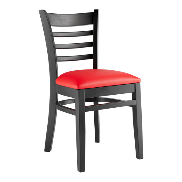 A Lancaster Table & Seating black wood ladder back chair with a red vinyl seat.