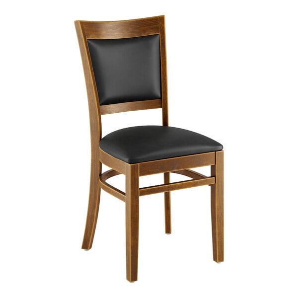 A Lancaster Table & Seating Sofia wooden chair with black vinyl seat.