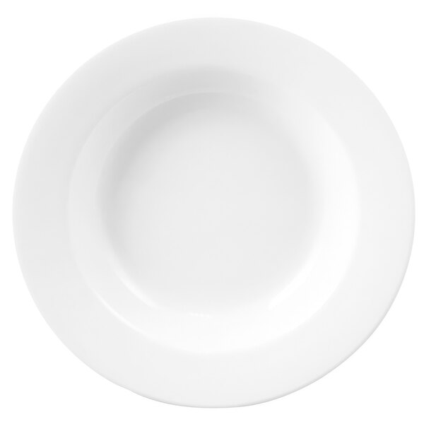 A close-up of a white Chef & Sommelier soup plate with a white border.