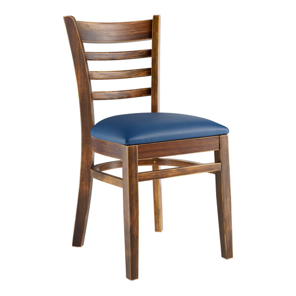 A Lancaster Table & Seating wooden ladder back chair with a navy vinyl seat.