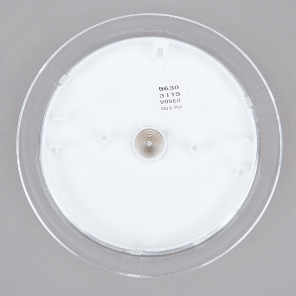 A round white object with a black label.