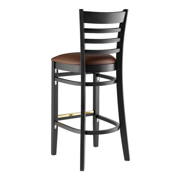A black Lancaster Table & Seating wood bar stool with a dark brown vinyl seat.