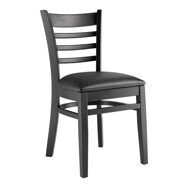 A Lancaster Table & Seating black wooden chair with black vinyl cushion.