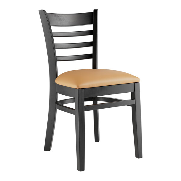 A black Lancaster Table & Seating wood restaurant chair with a light brown vinyl seat