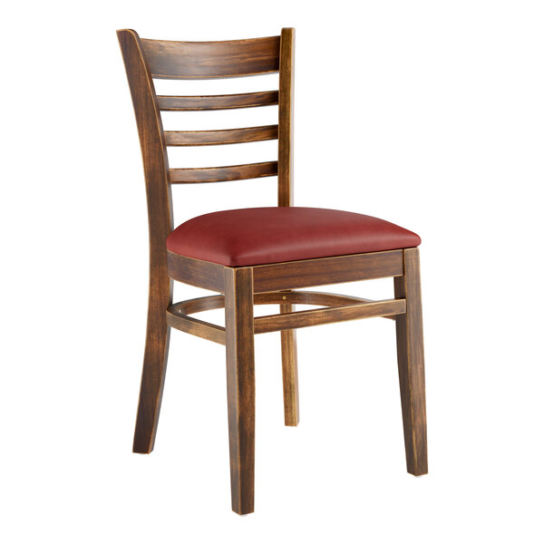 A Lancaster Table & Seating wood ladder back chair with burgundy vinyl seat.